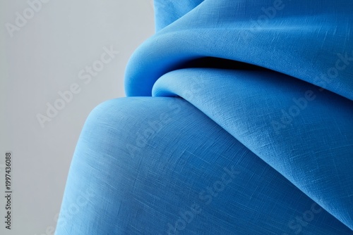 Smooth Blue Fabric Draped Softly on a Plain Background in a Light Setting