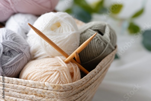 Yarn Balls and Knitting Needles Arranged in a Basket for a Crafting Project a...