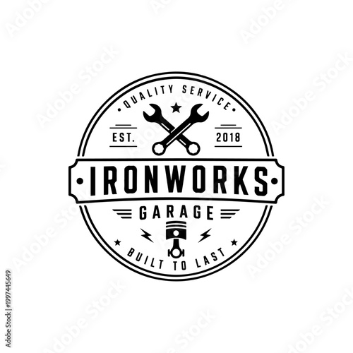 Ironworks garage logo with piston and wrenches.