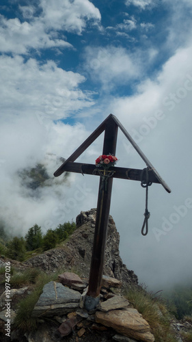 woodden cross on becca france peak in aosta valley during summer, italy