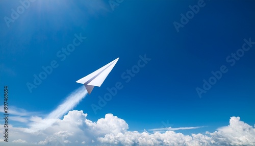 paper airplane in flight soaring against a bright blue sky summer angle
