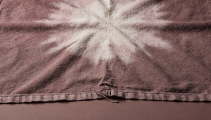 Mauve cotton tie dye fabric texture featuring a soft white pigment burst across a rose brown surface for sophisticated textile design and fashion backgrounds