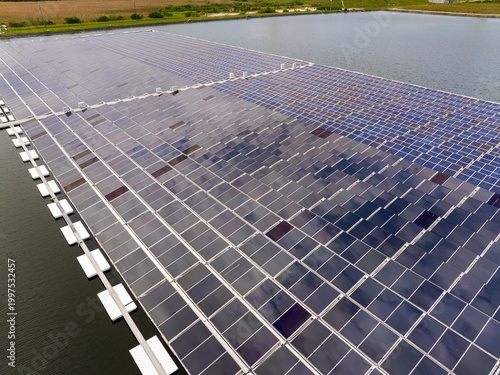 Innovative floating photovoltaic panels on water surface generating renewable electricity. Environmentally friendly solution for sustainable energy production without land use or carbon emissions