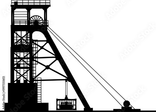 Mining headframe silhouette at an industrial excavation site