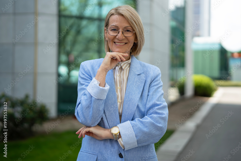 Fototapeta premium Confident mature businesswoman smiling looking at camera