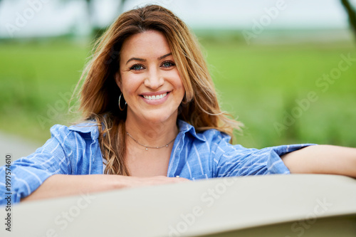 Happy woman smiling outdoors portrait enjoying natural lifestyle