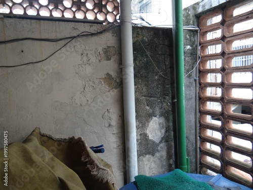 Plumbing Pipes and Peeling Paint on Weathered Wall