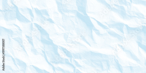 Crinkled light blue paper texture background with soft wrinkles and creases