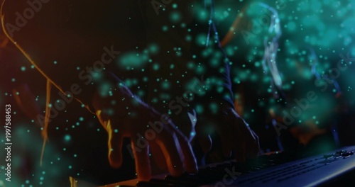 Typing hands wearing long-sleeve pressing keys at workstation, keyboard and teal particle overlay