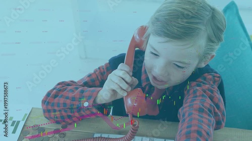 Boy lifting red handset, making pretend call while reaching keys and coins, tech overlays growing