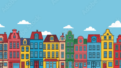 Row of colorful traditional european city houses with red and blue roofs stands under a clear sky with white clouds in summer.
