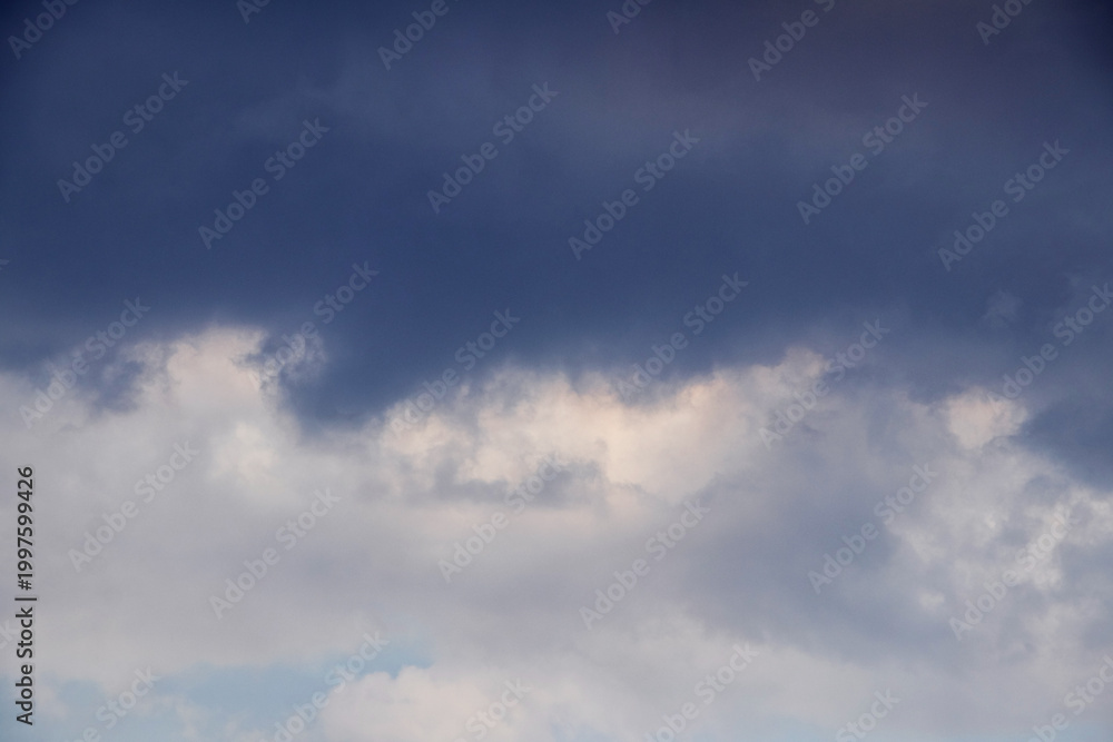 Fototapeta premium Dark blue sky with layer of white and grey clouds in lower part of frame panoramic view