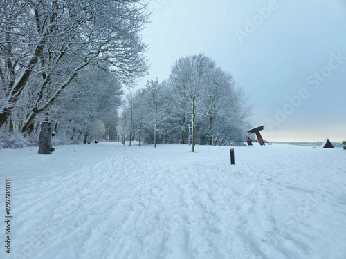 Urban winter scene. road covered with snow. Scenic image of spruces trees. Winter landscape - wooden house in snowy forest. Vertical photo. wooden bridge covered with snow.