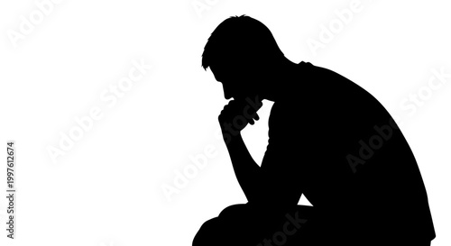 Bild auf Leinwand Silhouette of a man sitting in a pensive and thoughtful pose.