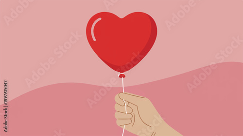 Hand holding red heart shaped balloon on pink background