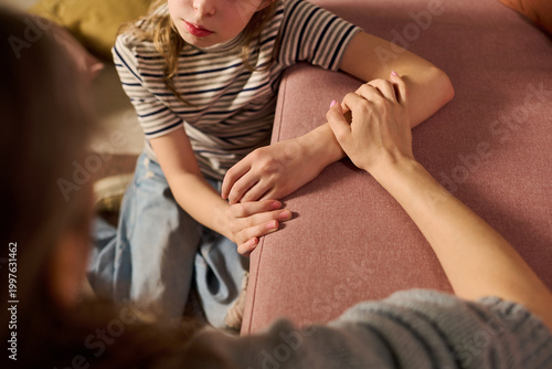 Obraz na płótnie Caucasian girl receiving comforting support from adult woman during difficult conversation, expressing care and trust