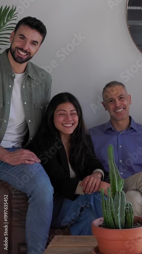 Vertical HD video of diverse group of successful business team sitting together at coworking office. Teamwork, leadership and collaboration concept