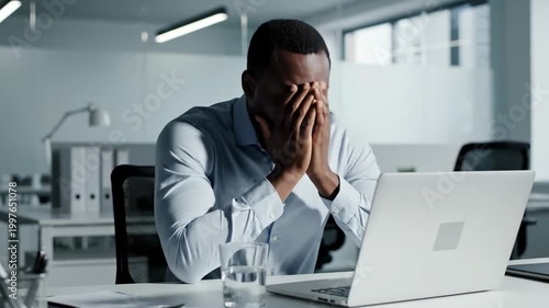 Stressed Businessman Experiencing Overwhelm At His Office Desk, Feeling Frustrated