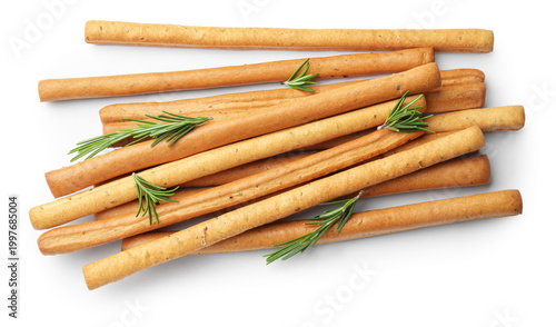 Foto Delicious grissini sticks and rosemary isolated on white, top view