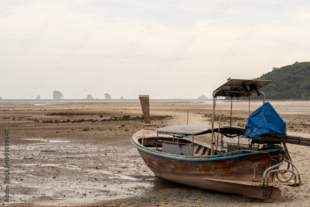 Fototapeta premium Traditional longtail boat on low tide beach Thailand