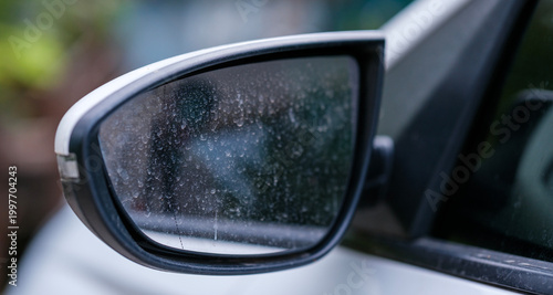Obraz na plátně Close up perspective of a white car side view mirror covered in thick dirt spots