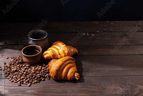 Slika na platnu Fresh croissants, coffee beans, and hot beverage brewing
