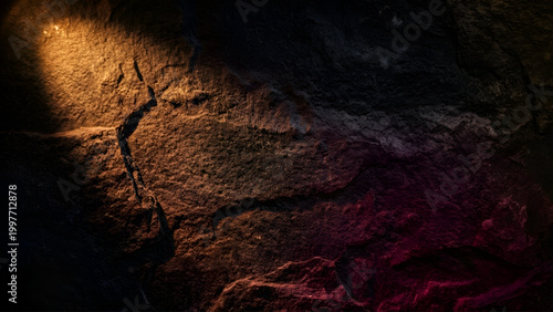 Abstract cinematic background of a rugged dark stone texture with warm golden spotlight and deep purple atmospheric shadows.