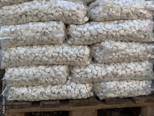 White pebbles in plastic bags on pallet