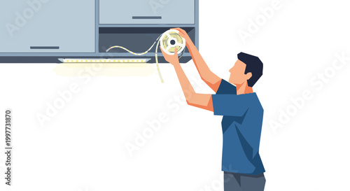 Man installing modern LED strip lighting under cabinet for home improvement project