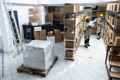 Bild auf Leinwand Black warehouse staff working in handling inventory for delivery, packaging cargo and dispatching goods