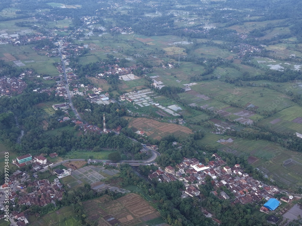 Fototapeta premium Aerial View of Rural Village with Agricultural Fields and Residential Areas