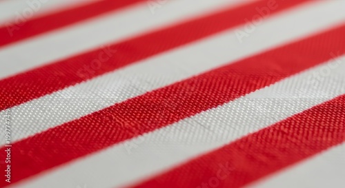 Bold red stripes adorn a soft fabric, creating a striking pattern. The diagonal lines add visual interest, and the texture enhances the appeal