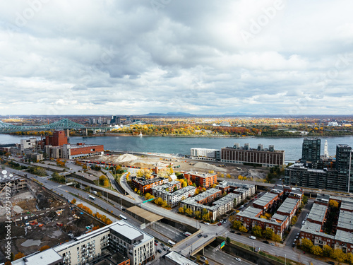 Bild auf Leinwand Aerial view of Montreal with bridges over St Lawrence River, autumn colors, Old Port and marina skyline