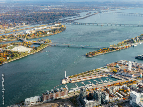 Bild auf Leinwand Aerial view of Montreal with bridges over St Lawrence River, autumn colors, Old Port and marina skyline