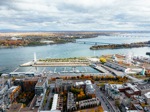 Billede på lærred Aerial view of Montreal with bridges over St Lawrence River, autumn colors, Old Port and marina skyline
