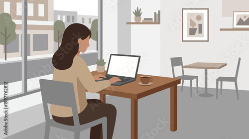 Person working on a laptop in a cozy cafe setting with a wooden desk.