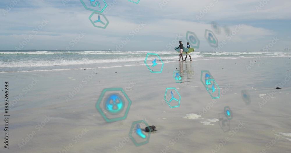 Fototapeta premium Walking two men carrying yellow surfboard along wet sand, wearing rashguards, holograms, copy space