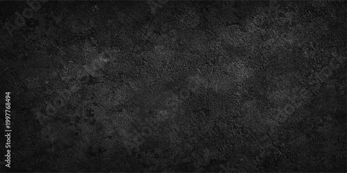 A dark vintage grunge texture featuring a rough aged stone wall background with a dirty gray concrete surface and a black weathered pattern for a moody wallpaper backdrop