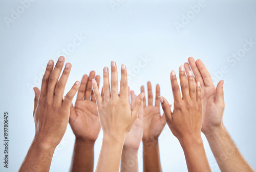 Diverse hands raised high symbolizing voting or unanimous agreement