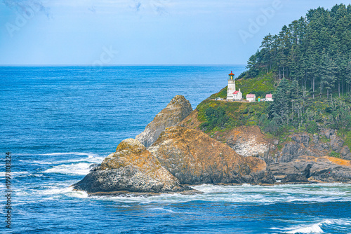 Canvas Print The historic Heceta Head Lighthouse and keeper's cottage perch atop a sea-battered rocky headland surrounded by dense forest on the central Oregon coast