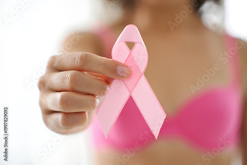 Woman holding pink ribbon symbol for breast cancer awareness image