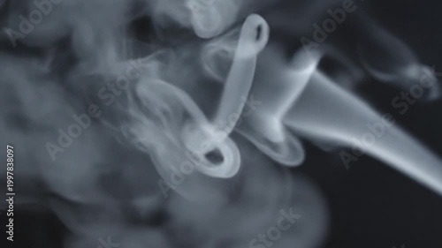 White smoke vapor flowing on dark black background