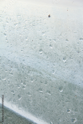 Photos A captivating macro photograph featuring natural morning dew droplets and condensation collected on the surface of a sheet of clear plastic