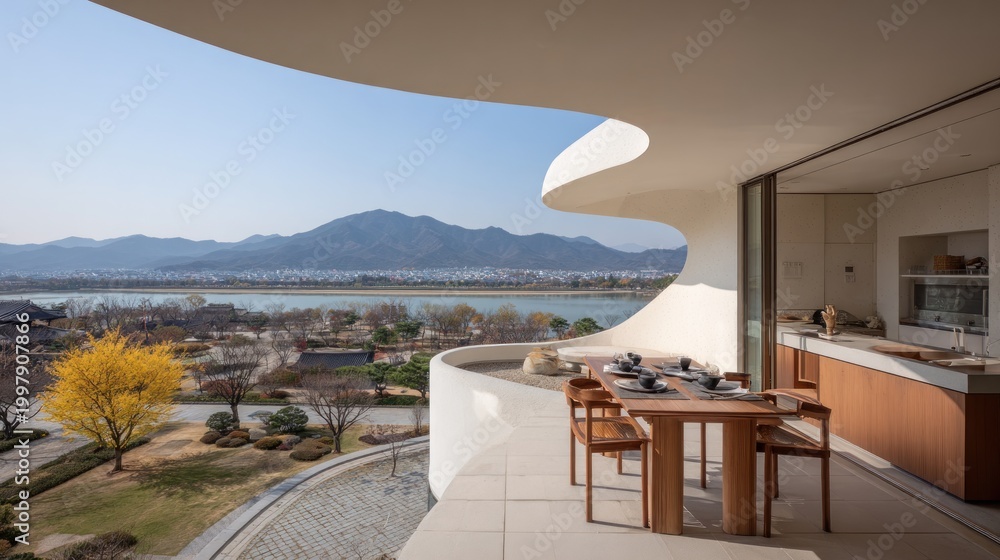 Fototapeta premium Modern balcony overlooking landscape with table and chairs on a sunny day