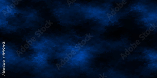Abstract nature background of a dark blue cloudscape where stormy clouds and light textures create a dramatic night sky backdrop