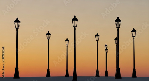 Row of vintage street lamps silhouetted against a sunset sky.
