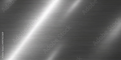 A polished silver stainless steel plate features a shiny brushed metal texture with a grey metallic surface and light reflections on a high-quality aluminum material background pattern