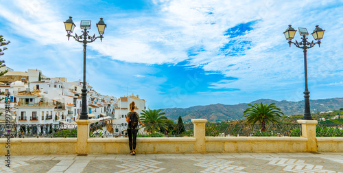 Fotografía young woman traveler enjoying view of frigiliana white village in spain