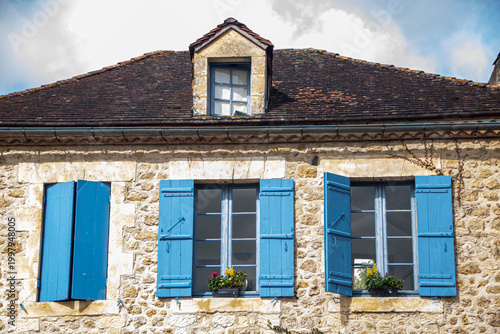 Traditional French stone house with blue shutters in Saint-Jean-de-Cole