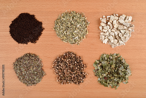 Assortment of dry teas on the wooden table. Top view. Herbal treatment concept.
